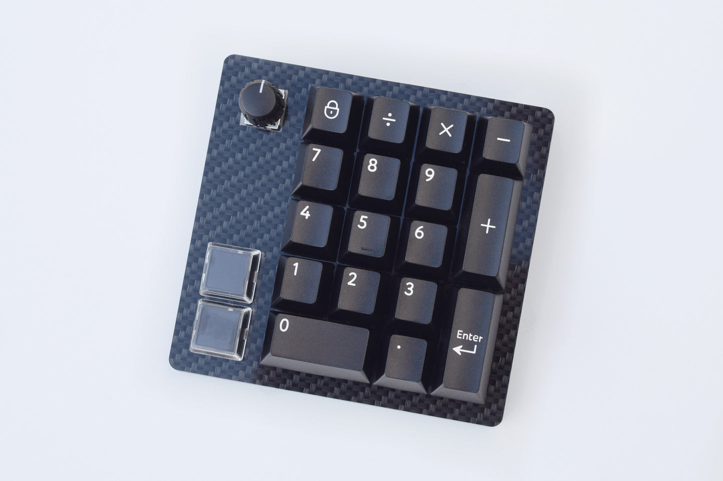 Small numerical keypad with carbon fiber texture on a white background